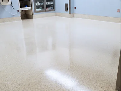 Professional maintenance team providing ongoing floor care in hospital lobby