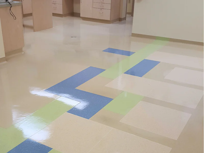 Professional VCT floor coating application showing colorful office floor results